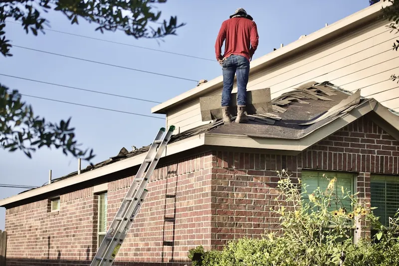 Professional roofer working on a residential roof in Bellefontaine Neighbors
